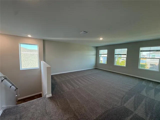 a large white kitchen with wooden floor and a sink