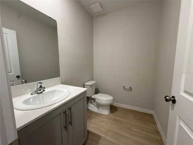 a bathroom with a sink toilet and a mirror