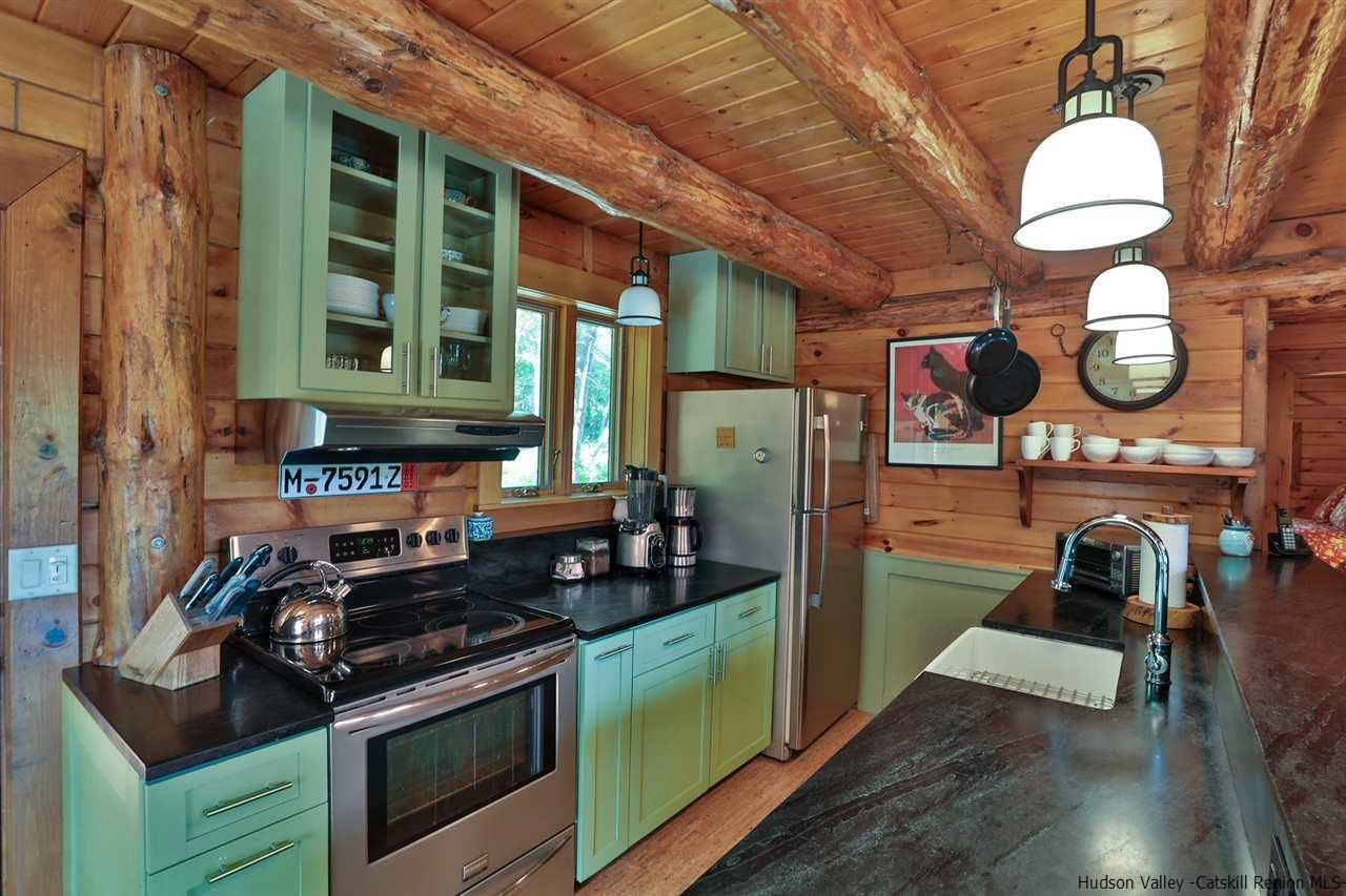 391 Tumbleweed Ranch Road West Kill, NY 12492 - Photo 12 of 35 a kitchen with stainless steel appliances granite countertop a stove and a sink