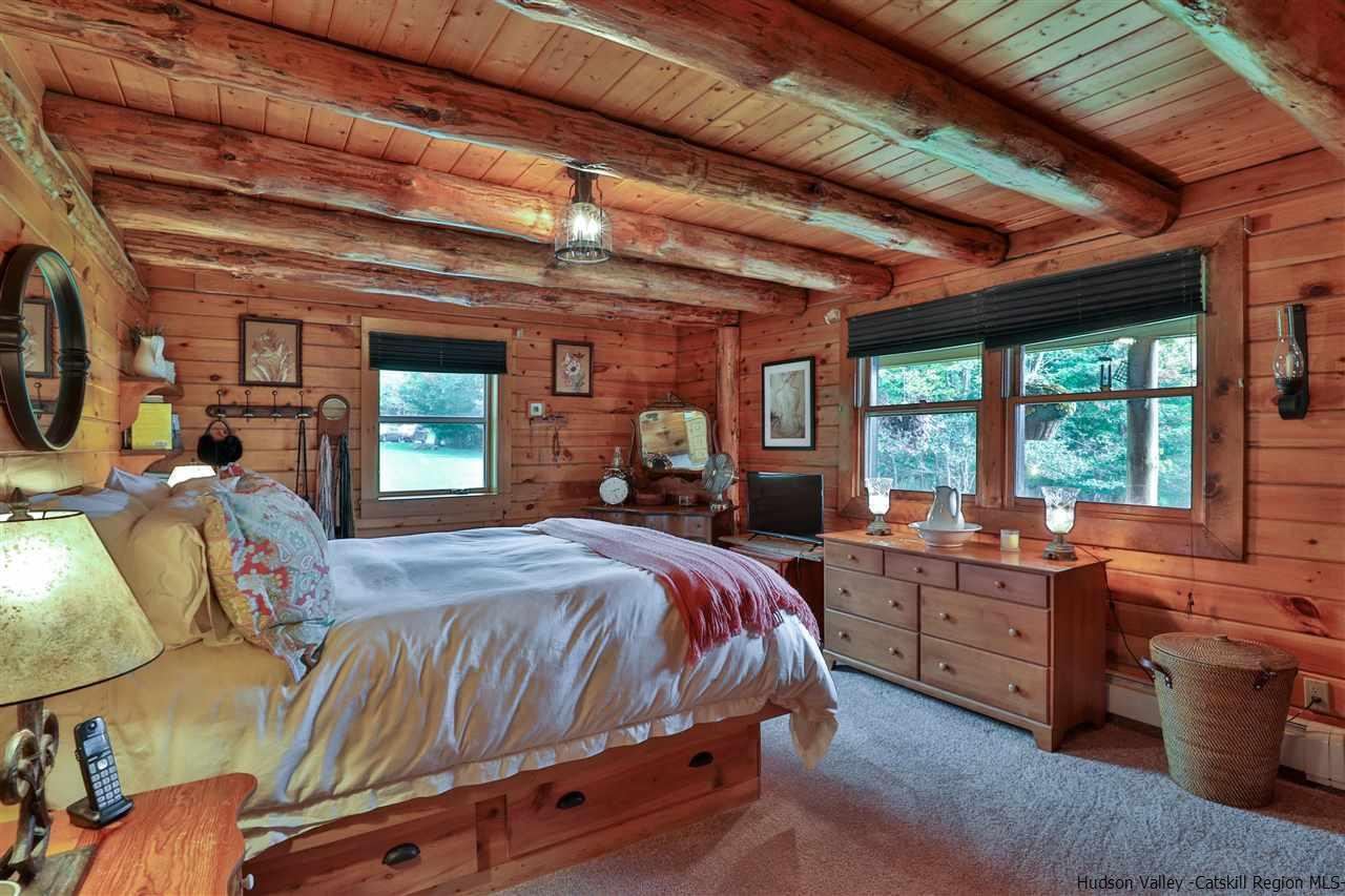 391 Tumbleweed Ranch Road West Kill, NY 12492 - Photo 14 of 35 a bed room with a bed and a large window