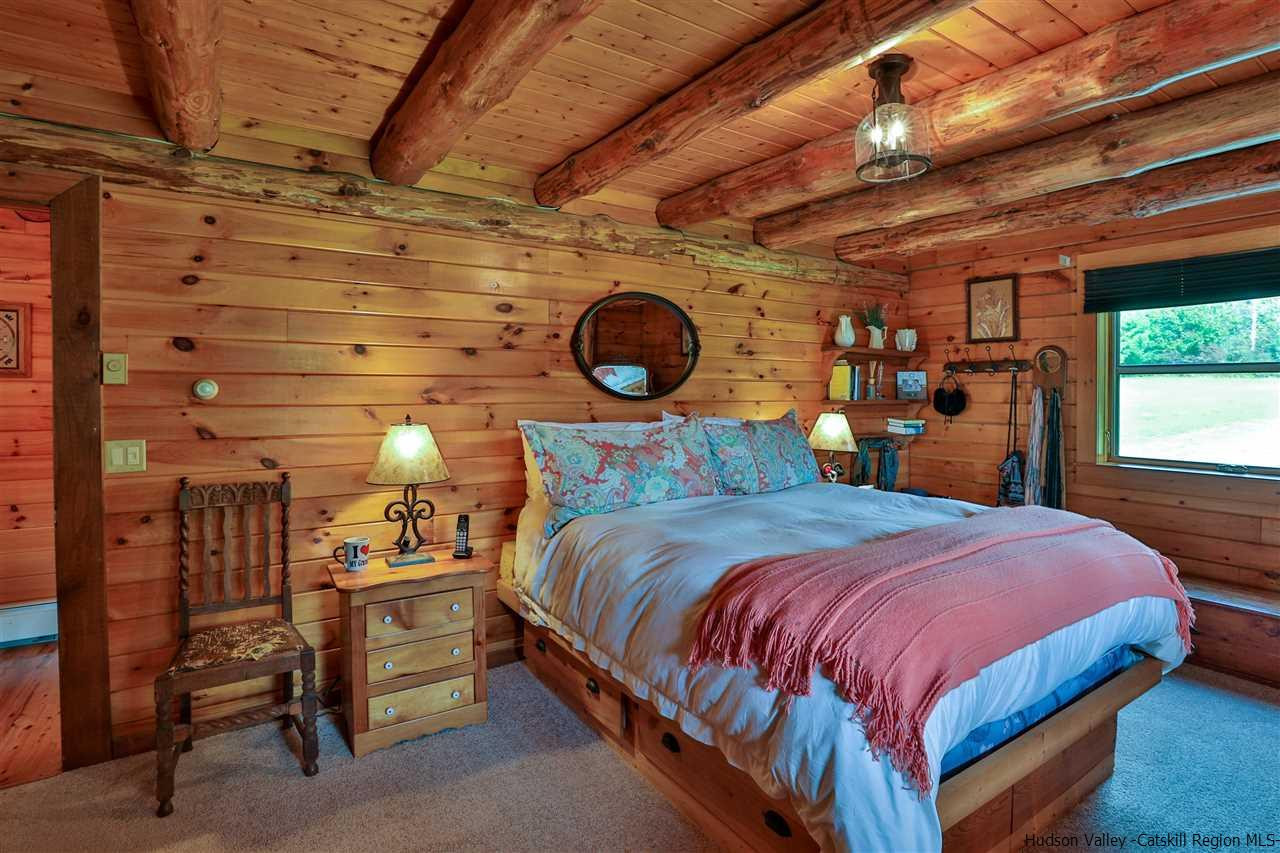 391 Tumbleweed Ranch Road West Kill, NY 12492 - Photo 16 of 35 a bedroom with a bed and a window