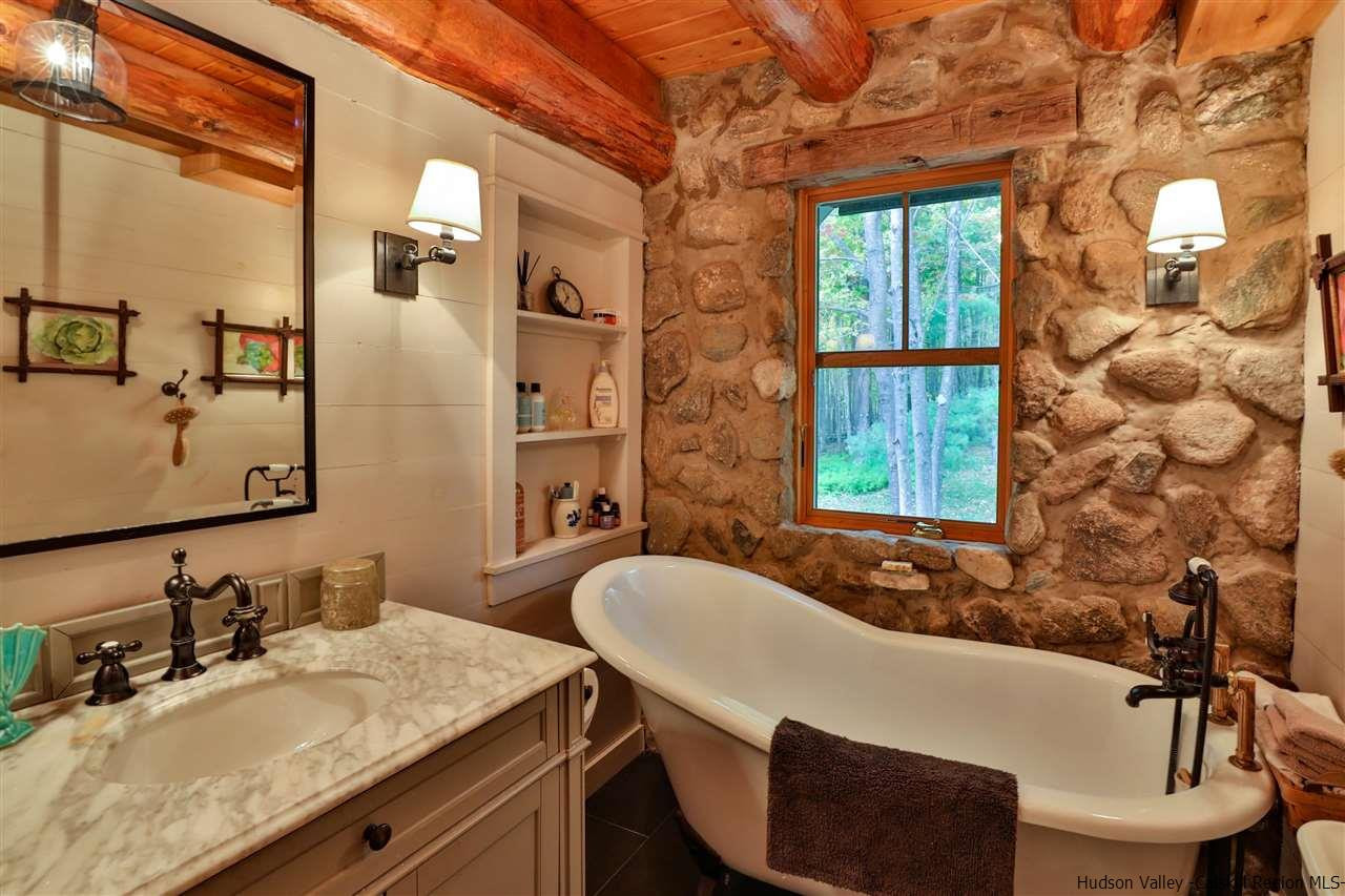 391 Tumbleweed Ranch Road West Kill, NY 12492 - Photo 17 of 35 a bathroom with a granite countertop sink mirror and a bathtub