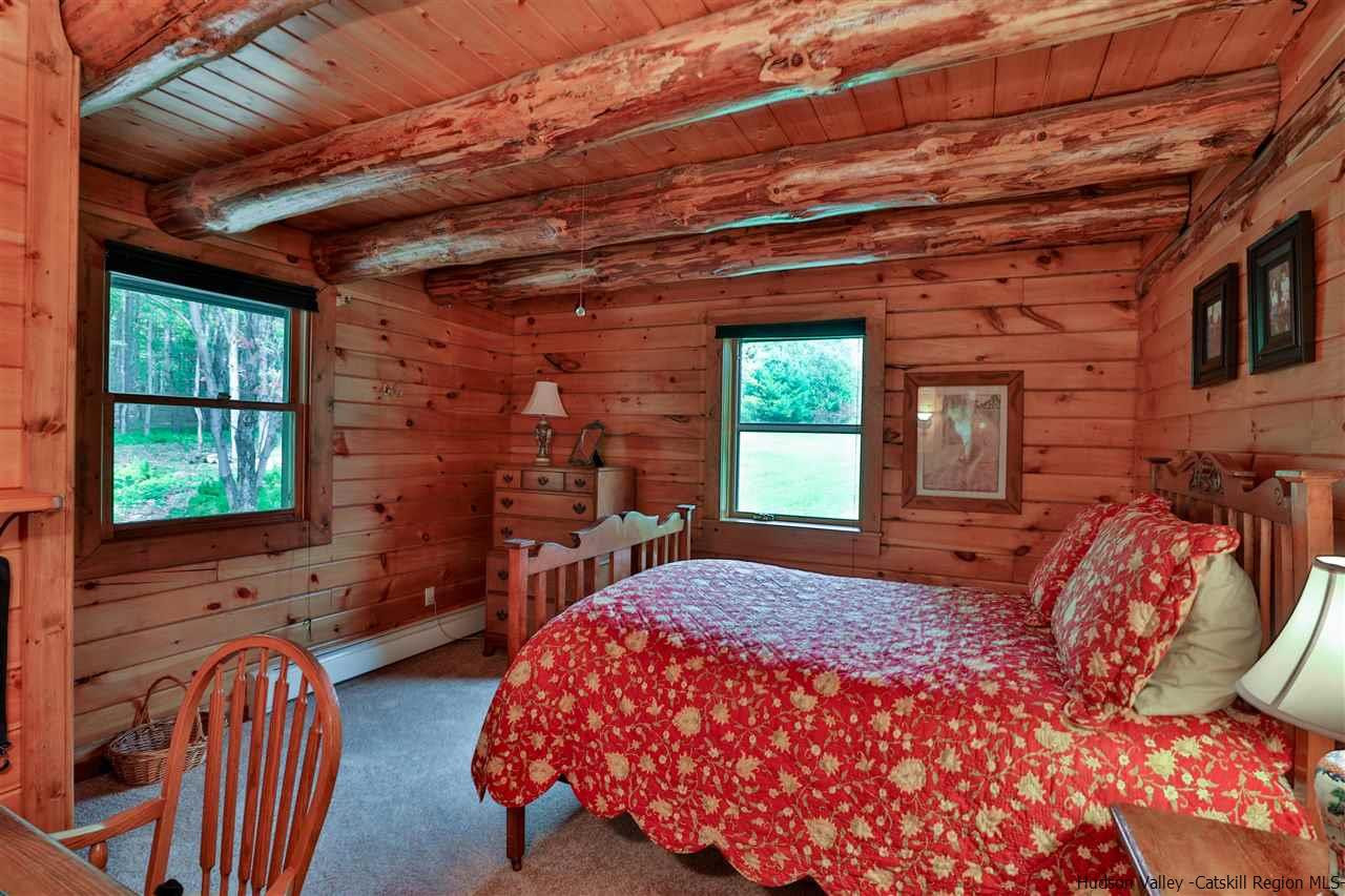 391 Tumbleweed Ranch Road West Kill, NY 12492 - Photo 18 of 35 a bed sitting in a bedroom next to a window