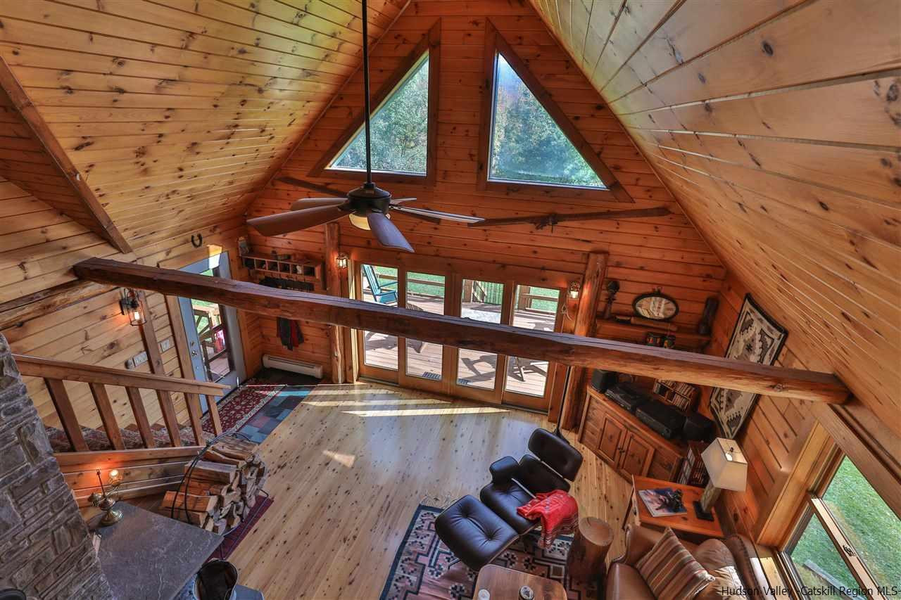 391 Tumbleweed Ranch Road West Kill, NY 12492 - Photo 23 of 35 a view of an chairs and table on the wooden floor