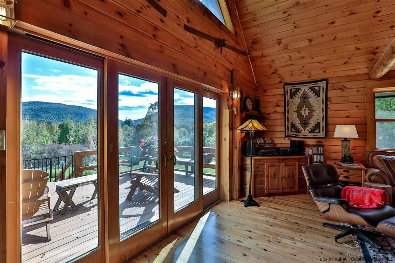 391 Tumbleweed Ranch Road West Kill, NY 12492 - Photo 28 of 35 a room with wooden furniture and wooden walls