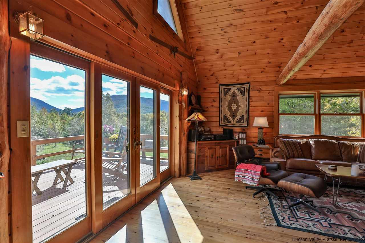 391 Tumbleweed Ranch Road West Kill, NY 12492 - Photo 5 of 35 a living room with furniture floor to ceiling window and wooden floor