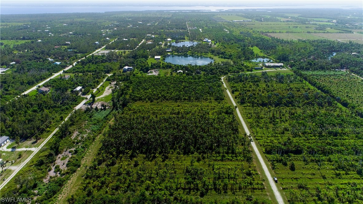 14900 Stringfellow Road Bokeelia, FL 33922 - Photo 28 of 38 a view of a green yard with large trees