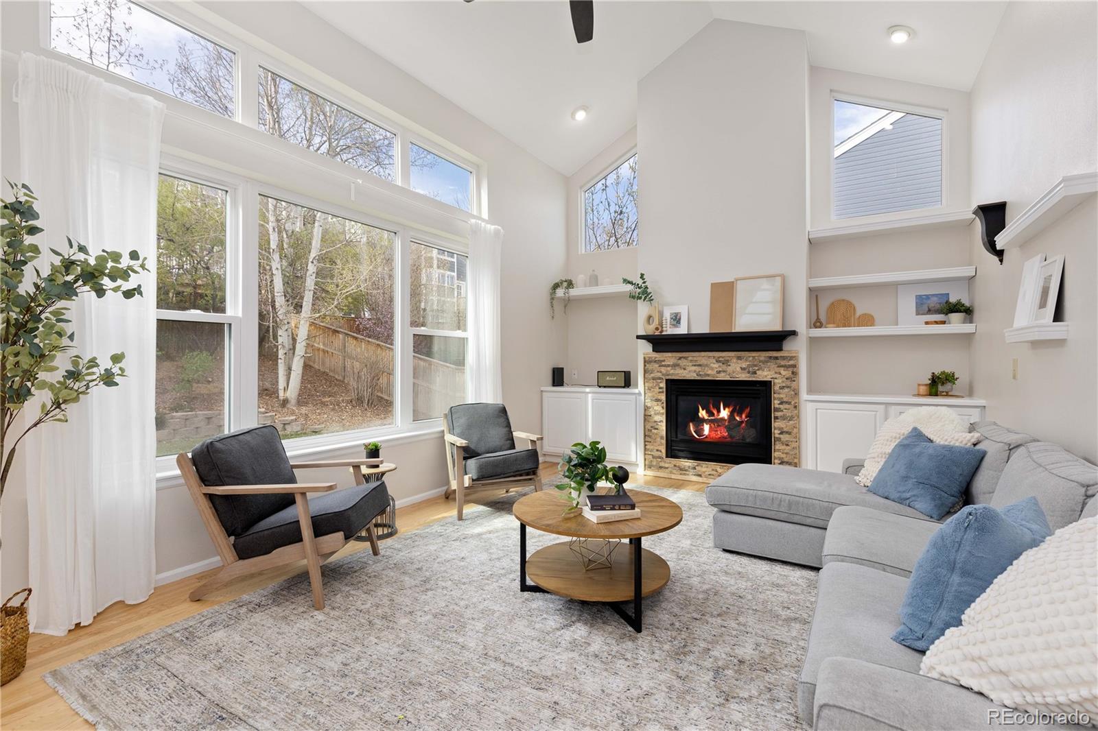 758 Huntington Place Highlands Ranch, CO 80126 - Photo 12 of 46 a living room with furniture and a fireplace