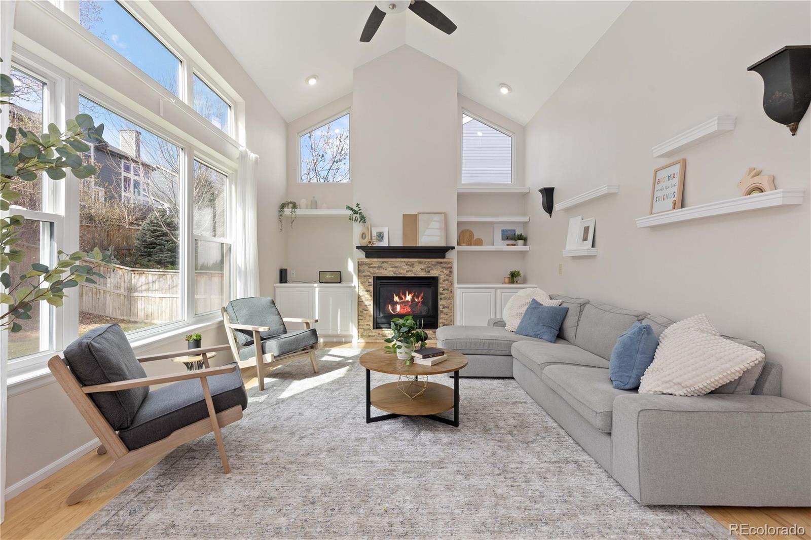758 Huntington Place Highlands Ranch, CO 80126 - Photo 13 of 46 a living room with furniture and a fireplace