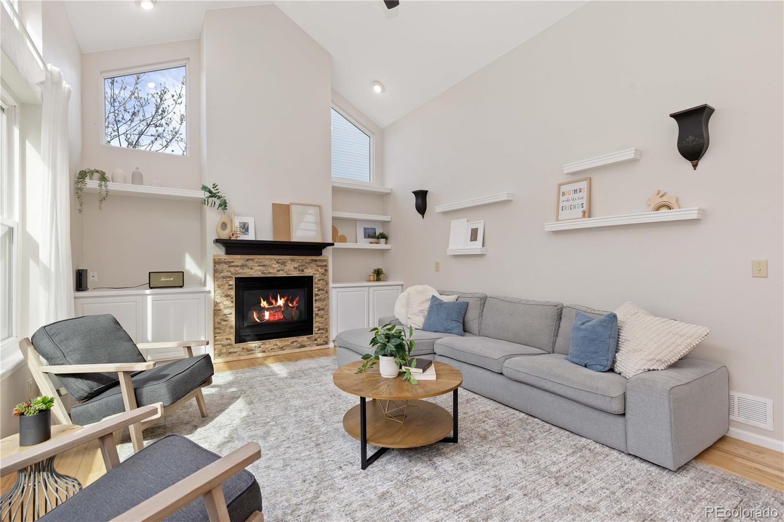 758 Huntington Place Highlands Ranch, CO 80126 - Photo 14 of 46 a living room with furniture and a fireplace