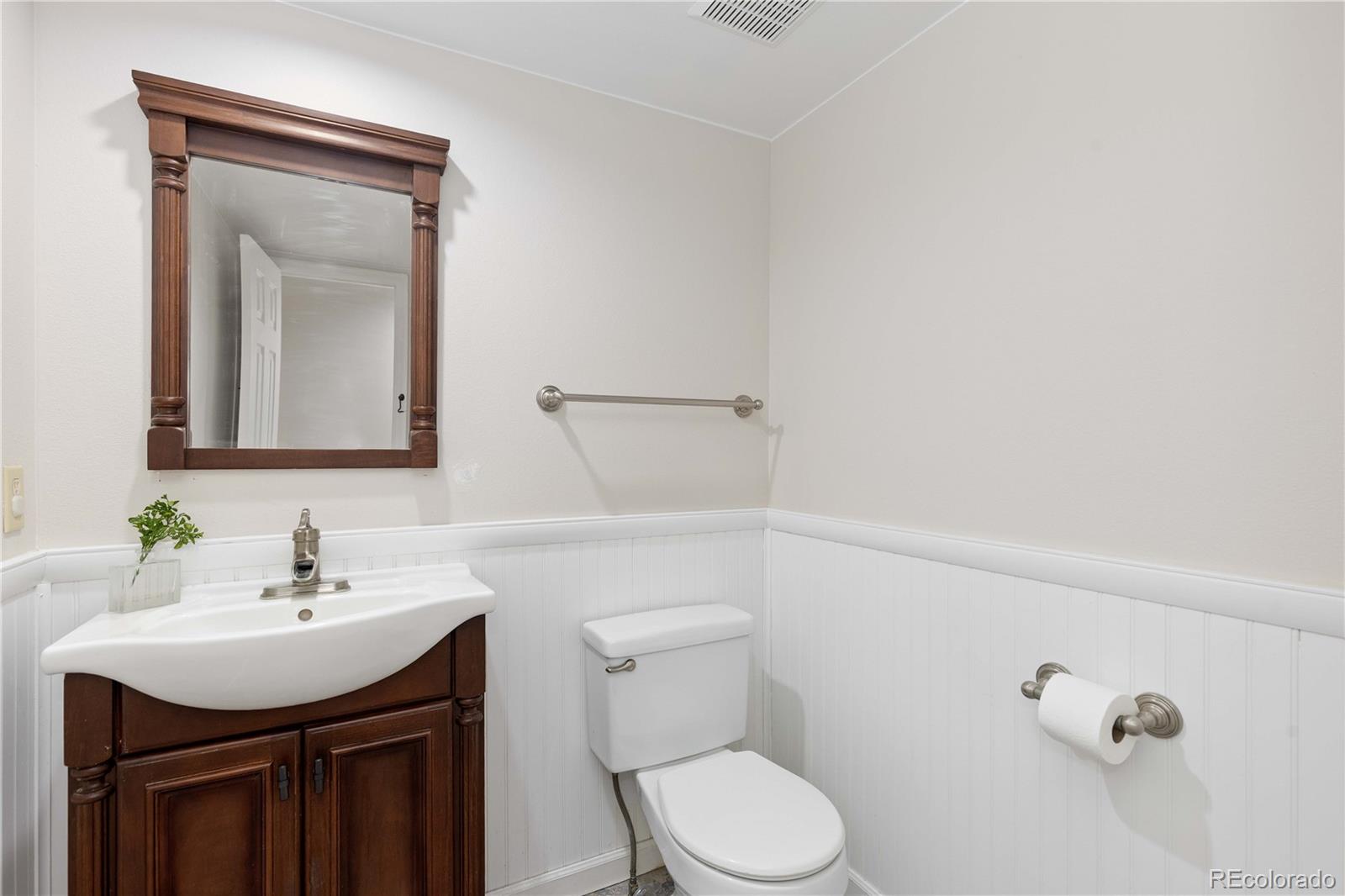 758 Huntington Place Highlands Ranch, CO 80126 - Photo 17 of 46 a bathroom with a toilet sink and mirror