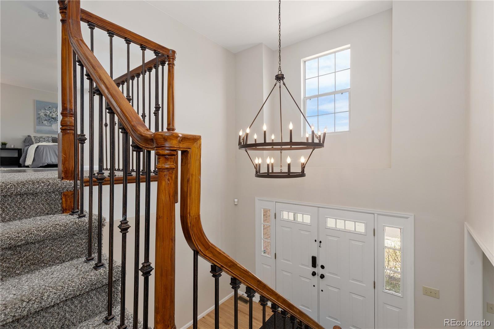 758 Huntington Place Highlands Ranch, CO 80126 - Photo 18 of 46 a view of staircase with railing and a chandelier