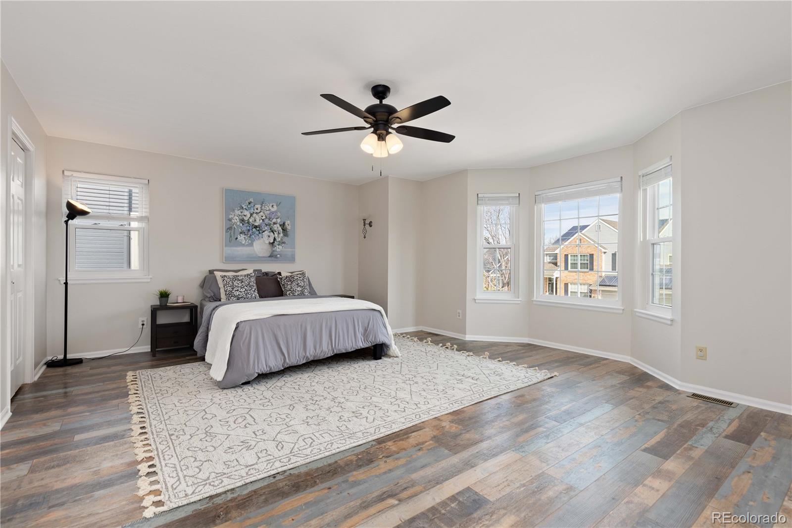 758 Huntington Place Highlands Ranch, CO 80126 - Photo 19 of 46 a bedroom with a large bed and a chandelier