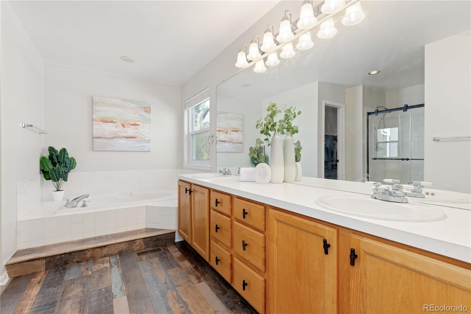 758 Huntington Place Highlands Ranch, CO 80126 - Photo 21 of 46 a spacious bathroom with double vanity a mirror and a bathtub
