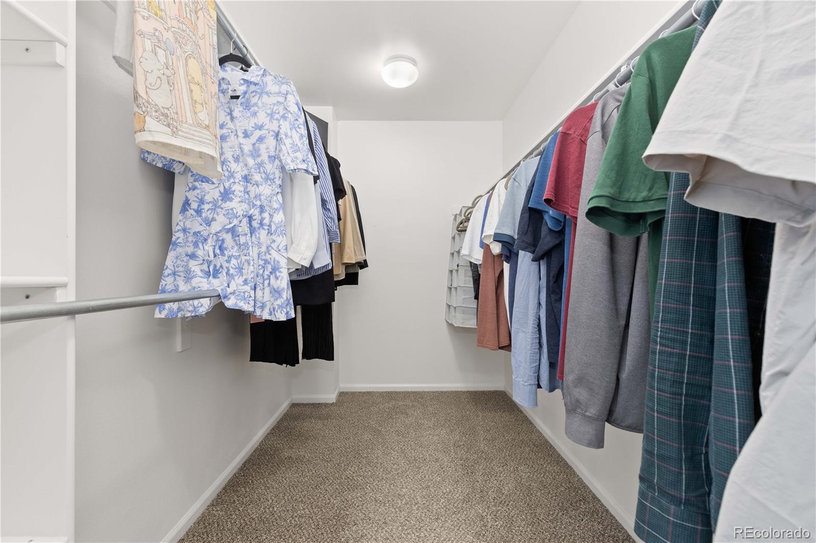 758 Huntington Place Highlands Ranch, CO 80126 - Photo 23 of 46 a view of walk in closet with clothes