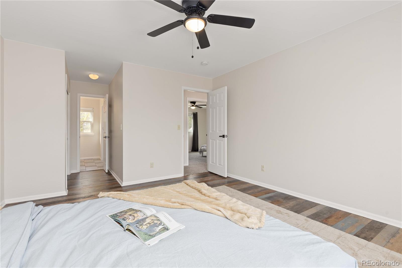 758 Huntington Place Highlands Ranch, CO 80126 - Photo 26 of 46 a view of a livingroom with wooden floor and a ceiling fan