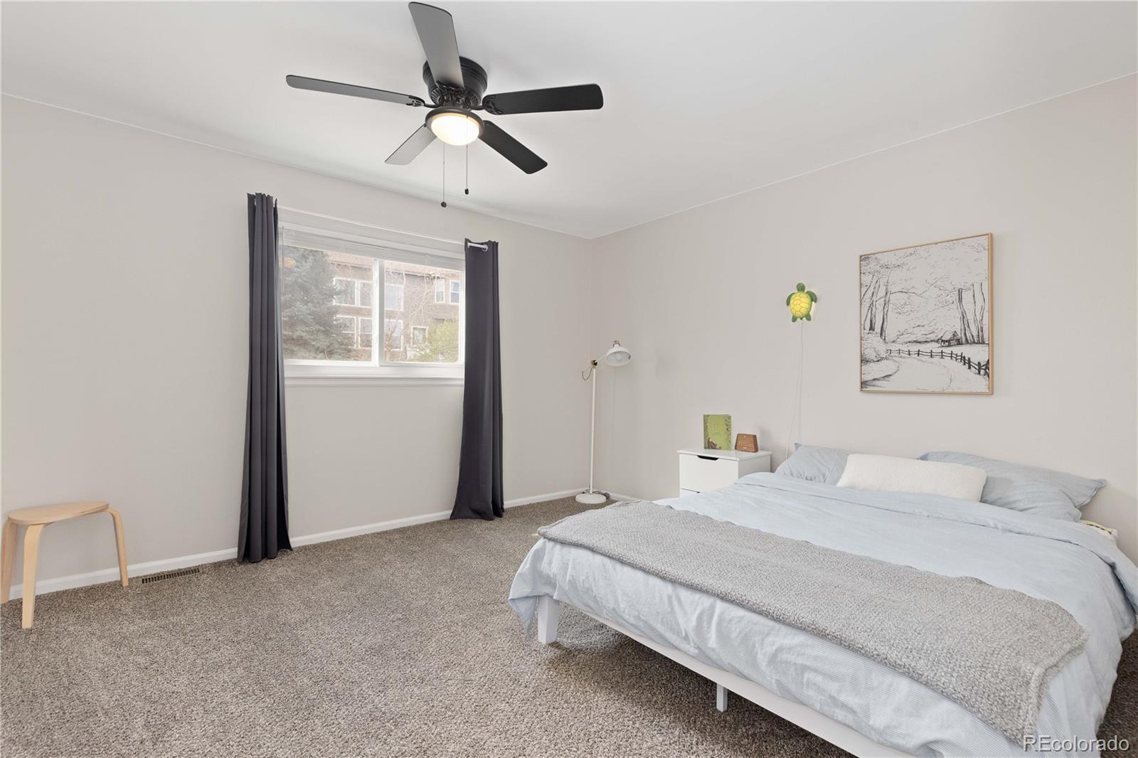 758 Huntington Place Highlands Ranch, CO 80126 - Photo 29 of 46 a bedroom with a bed a window and painting on the wall