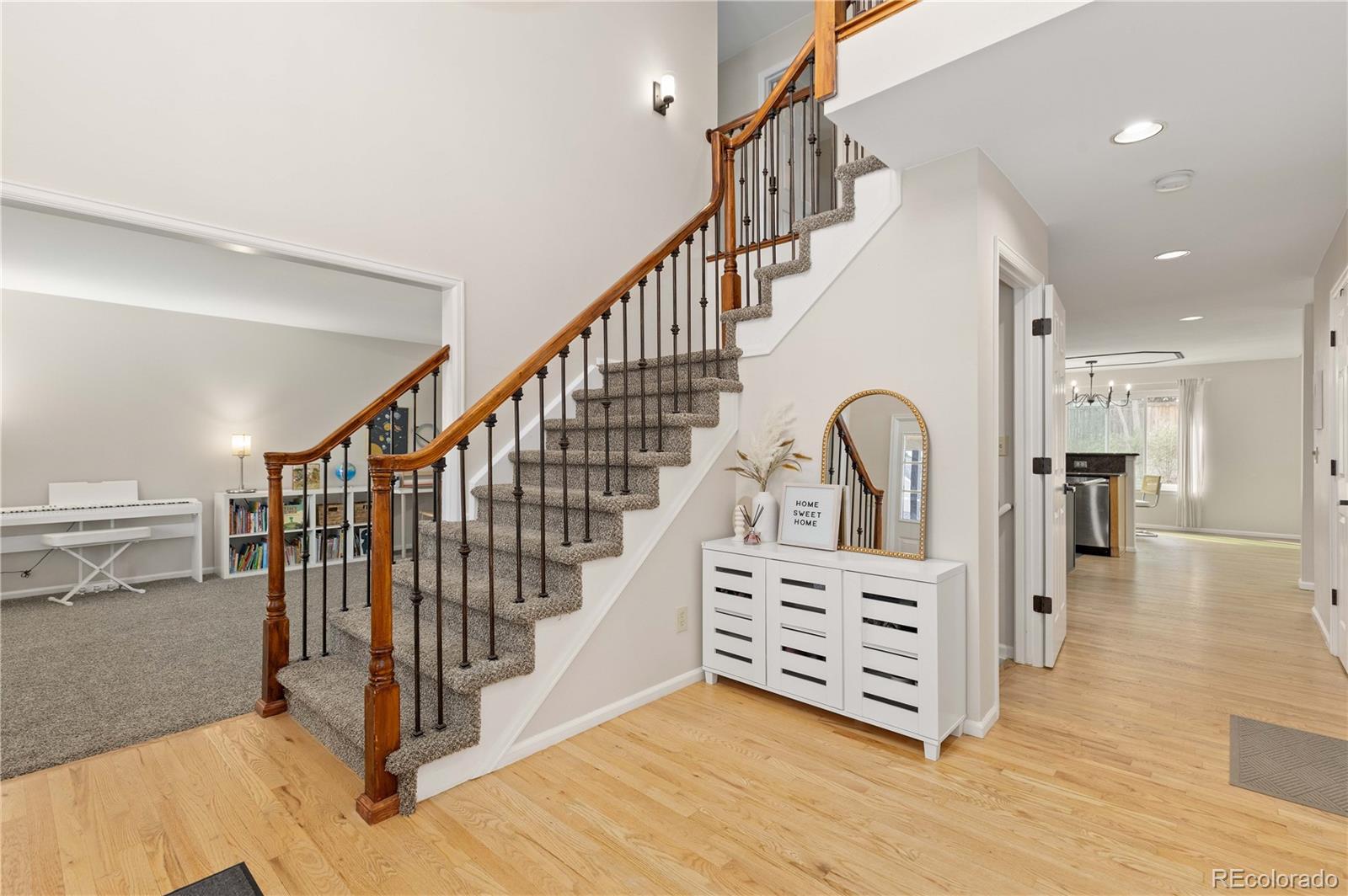758 Huntington Place Highlands Ranch, CO 80126 - Photo 3 of 46 a view of entryway with wooden floor and stairs