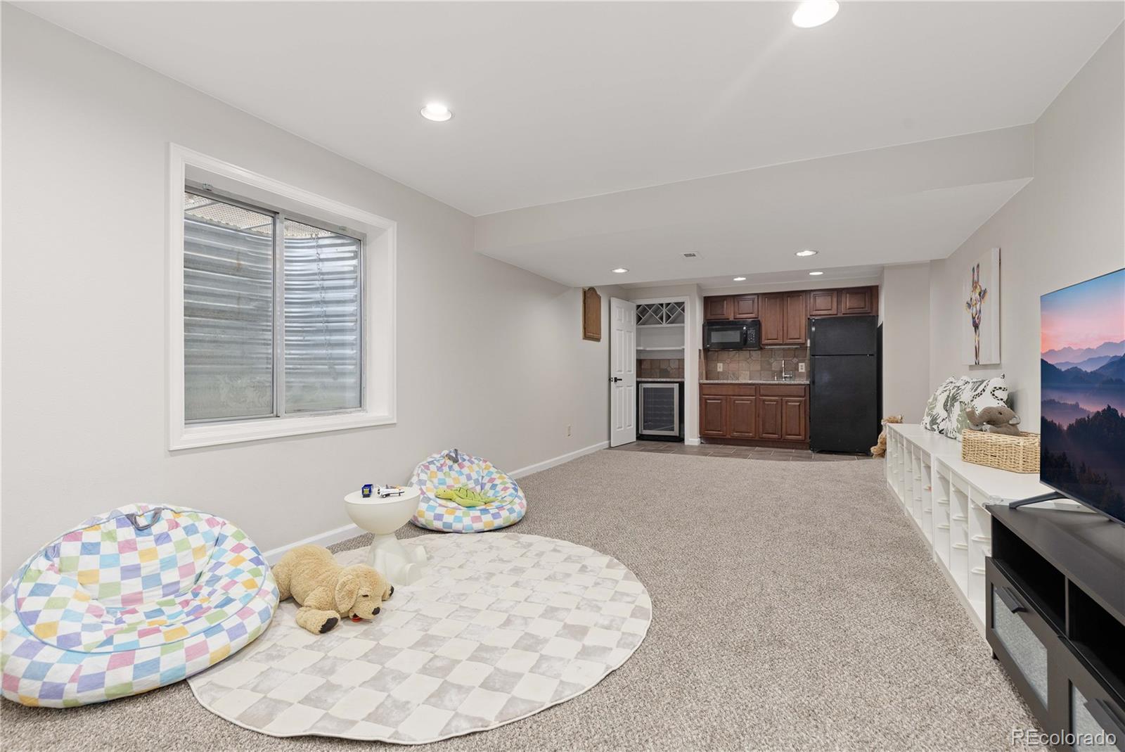 758 Huntington Place Highlands Ranch, CO 80126 - Photo 32 of 46 a living room with furniture and fireplace