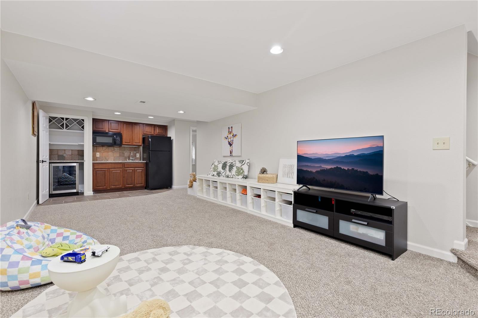758 Huntington Place Highlands Ranch, CO 80126 - Photo 33 of 46 a living room with furniture and flat screen tv