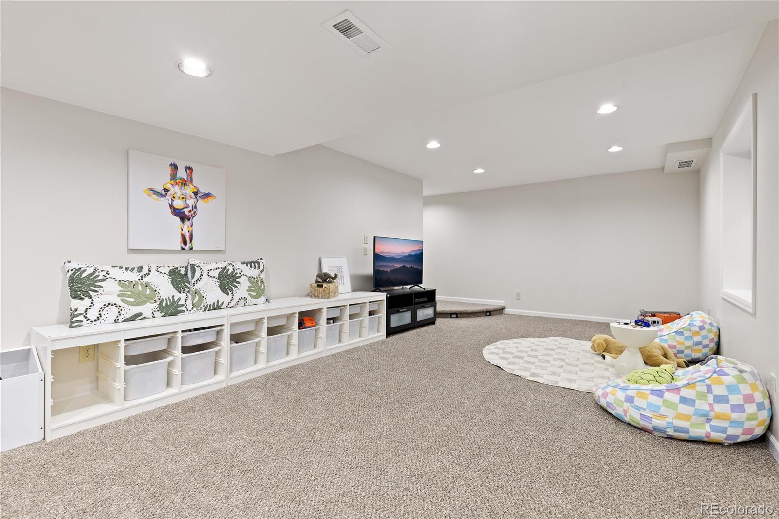 758 Huntington Place Highlands Ranch, CO 80126 - Photo 34 of 46 a living room with furniture and a flat screen tv