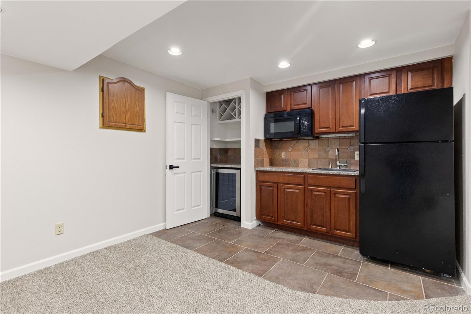 758 Huntington Place Highlands Ranch, CO 80126 - Photo 35 of 46 a kitchen with a refrigerator and a sink