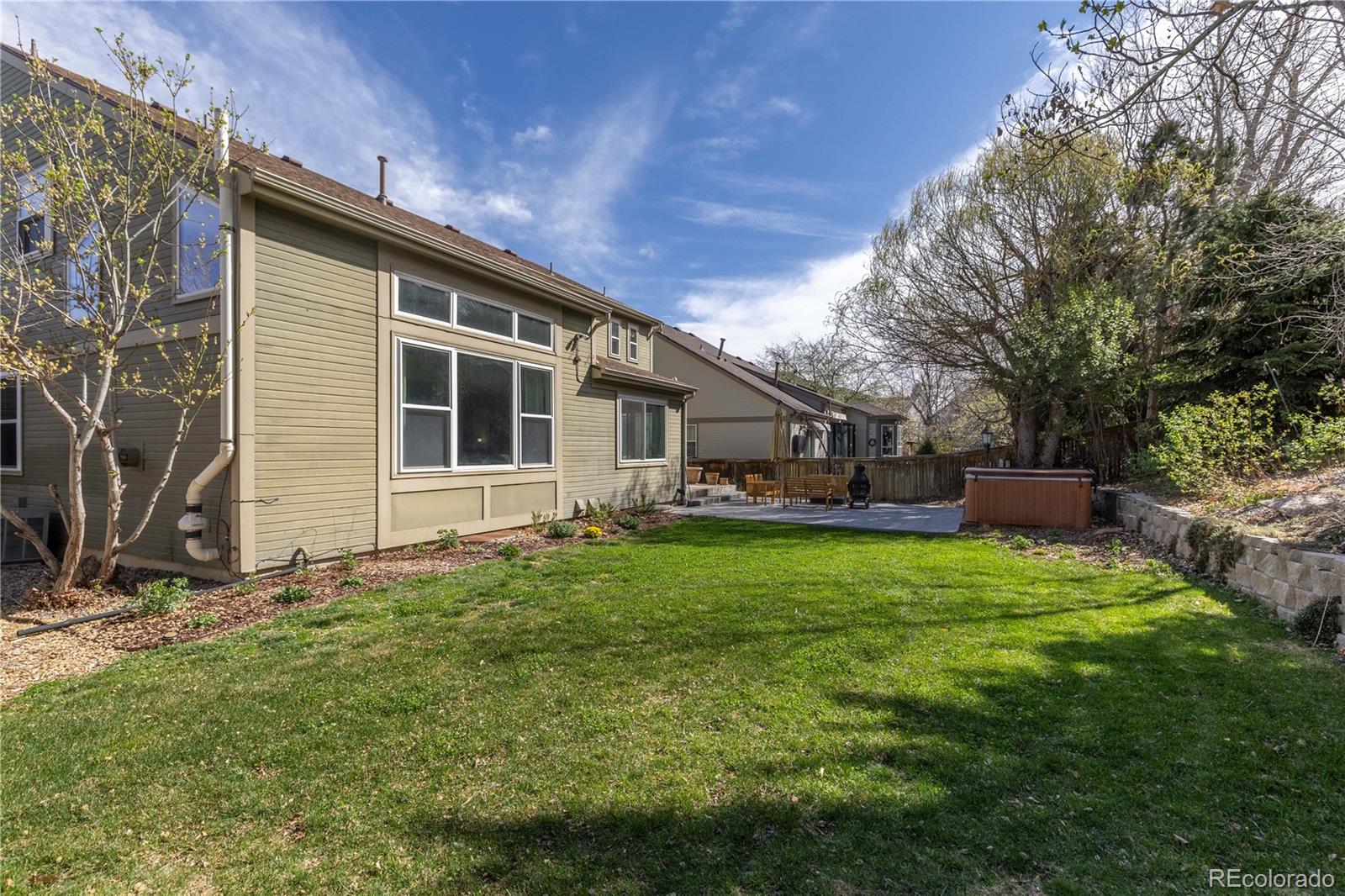 758 Huntington Place Highlands Ranch, CO 80126 - Photo 40 of 46 a backyard of a house with table and chairs