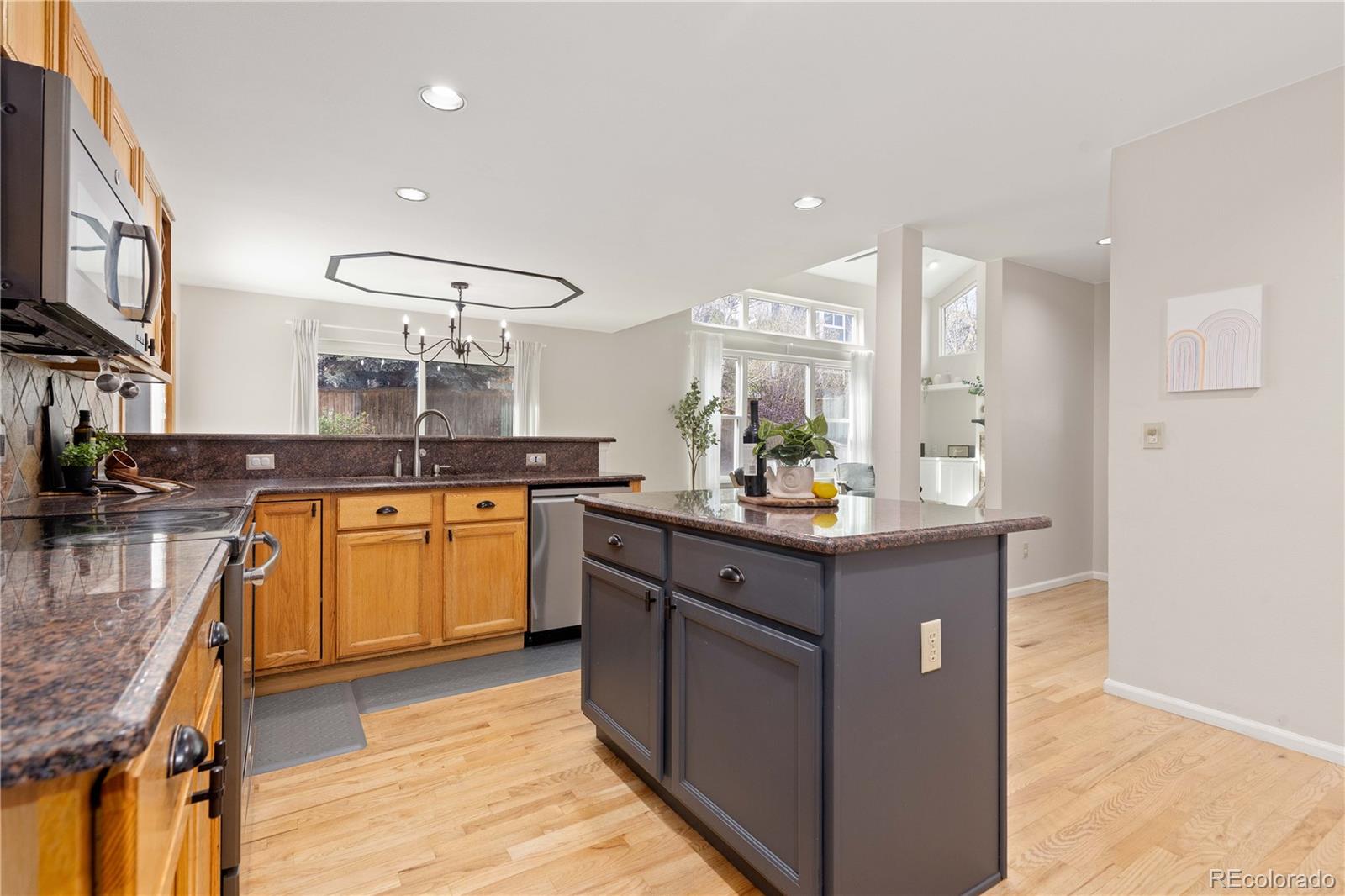 758 Huntington Place Highlands Ranch, CO 80126 - Photo 8 of 46 a kitchen with stainless steel appliances granite countertop a sink and cabinets