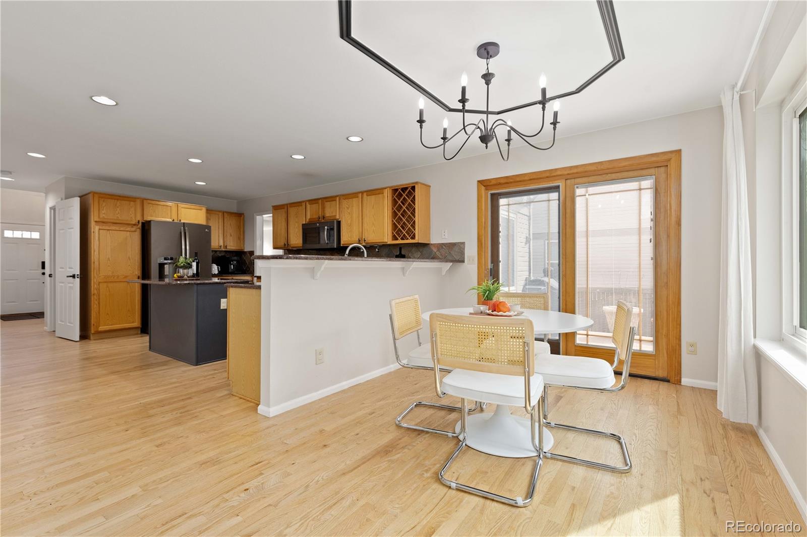 758 Huntington Place Highlands Ranch, CO 80126 - Photo 10 of 46 a kitchen with stainless steel appliances kitchen island granite countertop a refrigerator and microwave
