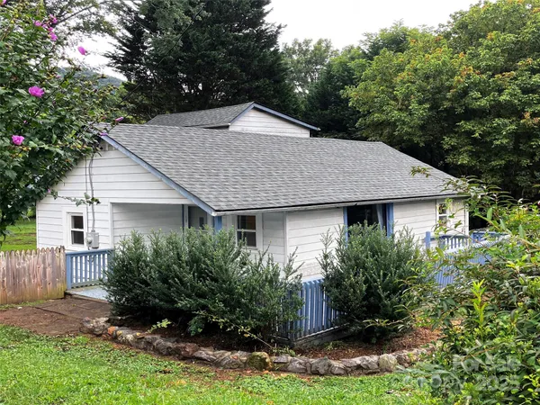 a house that has a tree in front of it