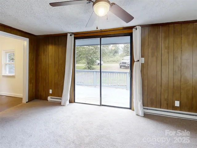 an empty room with sliding door and wooden floor