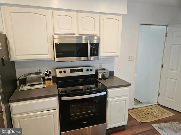 a kitchen with stainless steel appliances granite countertop a sink and cabinets