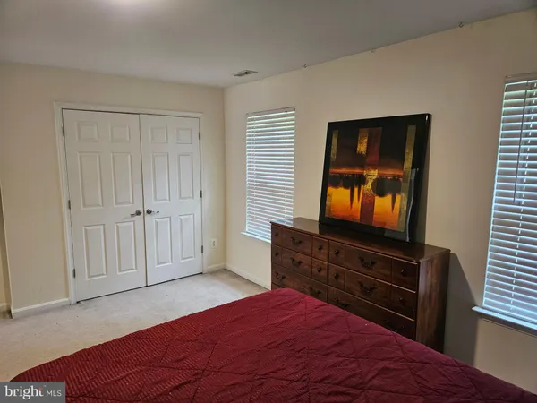 a bed sitting in a room next to a window