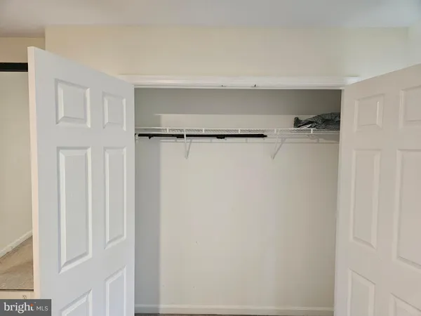 a bedroom with a bed tv and a large mirror