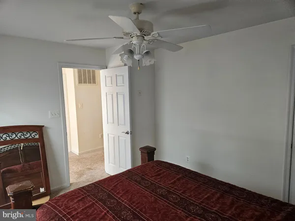 a living room with stainless steel appliances furniture and a rug