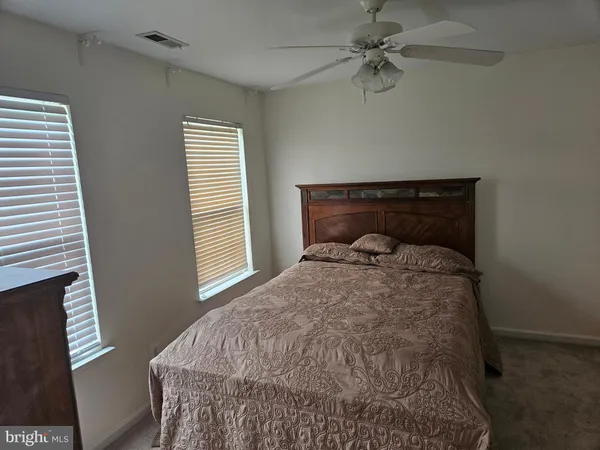 a view of a room with furniture and wooden floor