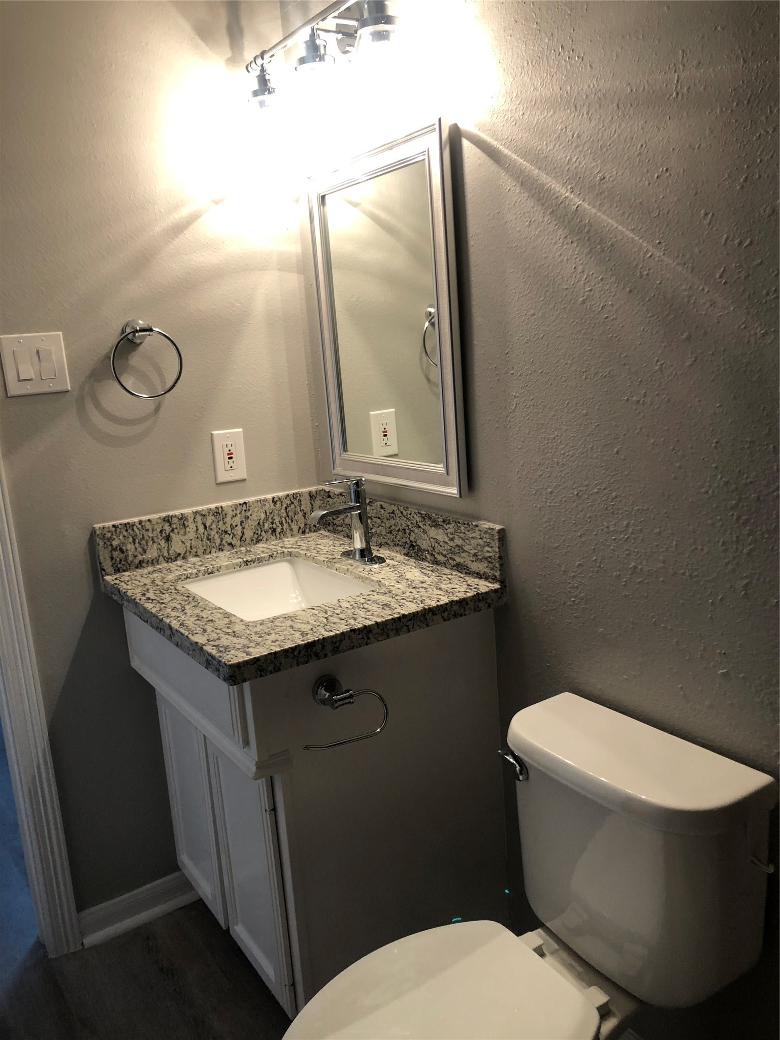 1906 Vermont Street, Unit E Houston, TX 77019 - Photo 4 of 9 a bathroom with a granite countertop toilet sink and mirror