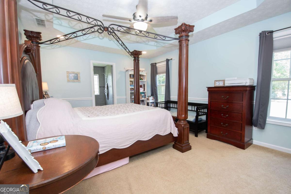 737 John Lovelace Road LaGrange, GA 30241 - Photo 13 of 46 a bedroom with a bed and wooden floor