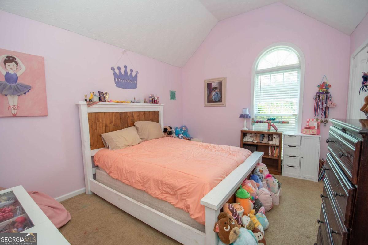 737 John Lovelace Road LaGrange, GA 30241 - Photo 18 of 46 a bedroom with a bed and a flat tv screen on the dresser