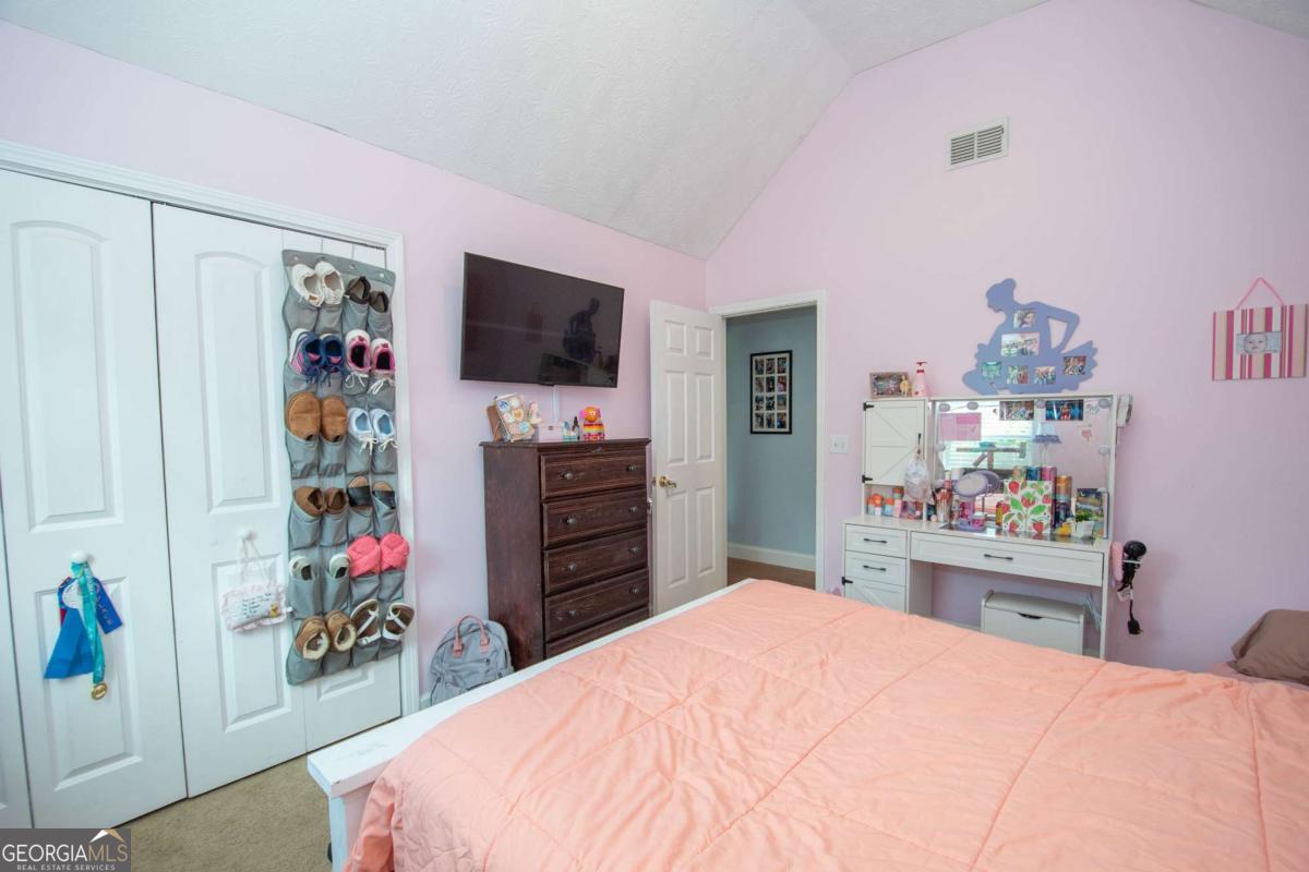 737 John Lovelace Road LaGrange, GA 30241 - Photo 19 of 46 a bedroom with a bed and a flat screen tv