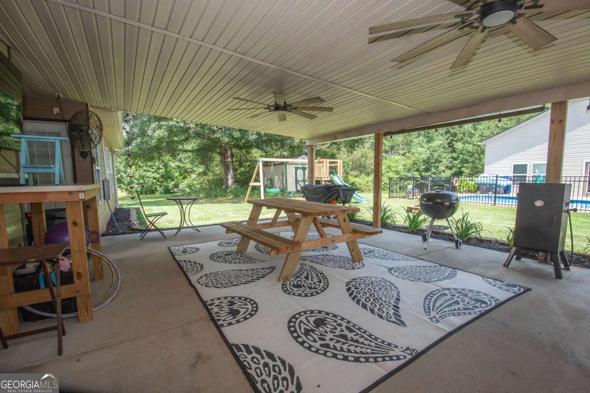 737 John Lovelace Road LaGrange, GA 30241 - Photo 27 of 46 a view of a patio with couches chairs and a table and chairs with wooden floor