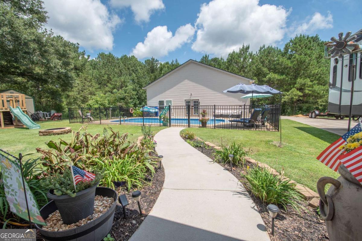 737 John Lovelace Road LaGrange, GA 30241 - Photo 28 of 46 a house with garden in front of it