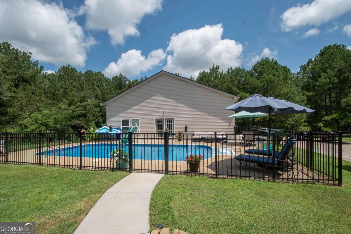 737 John Lovelace Road LaGrange, GA 30241 - Photo 30 of 46 a view of a house with backyard and sitting area