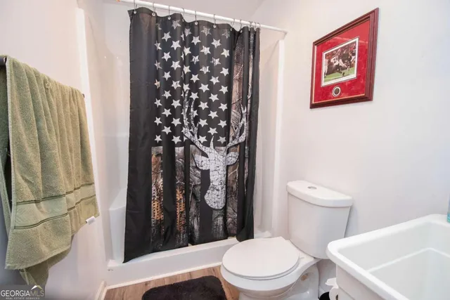 a white toilet sitting next to a bathroom sink