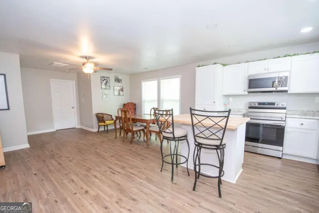 a view of a dining room with furniture and wooden floor