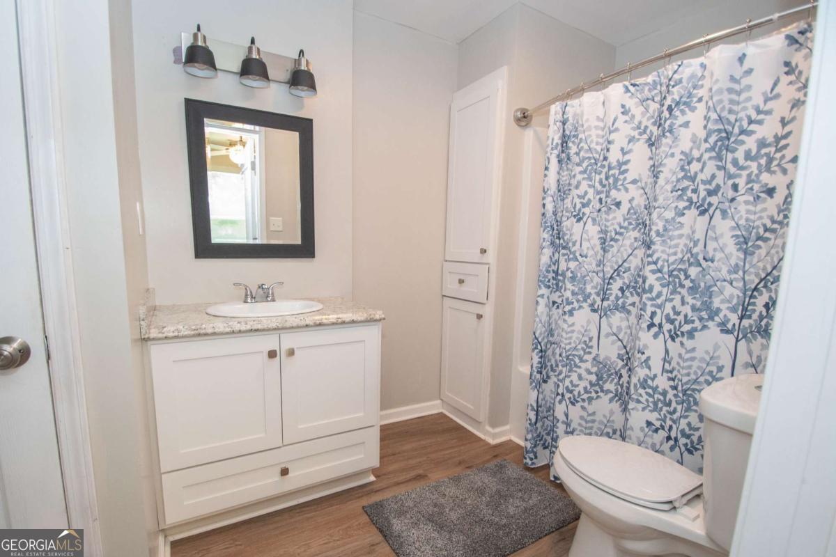 737 John Lovelace Road LaGrange, GA 30241 - Photo 43 of 46 a bathroom with a sink a toilet and shower curtain
