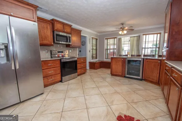 a kitchen with stainless steel appliances granite countertop a refrigerator and a stove top oven