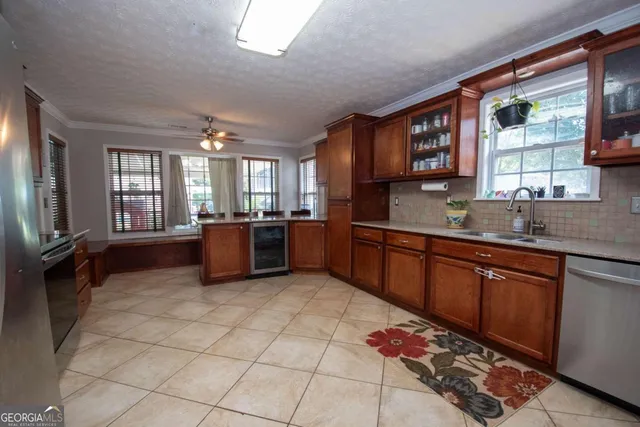 a kitchen with stainless steel appliances granite countertop a sink stove and cabinets