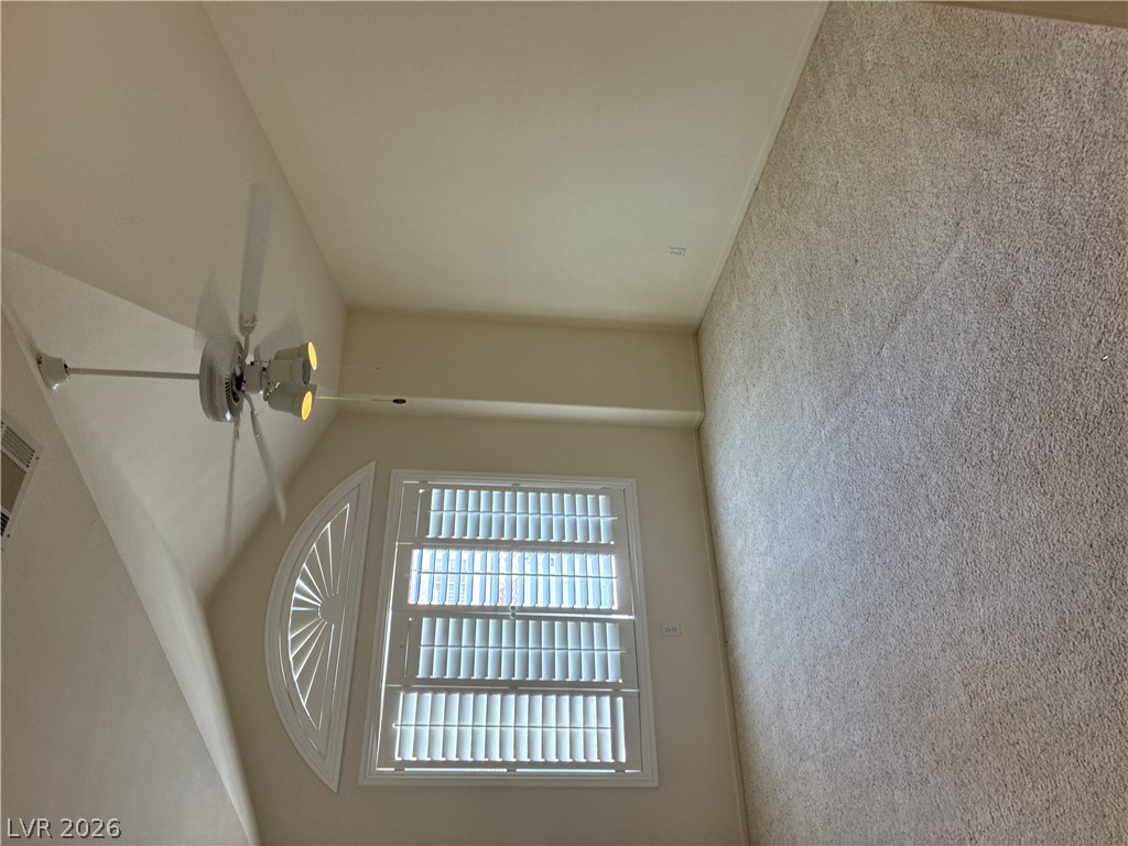 5272 Island Chain Road Las Vegas, NV 89118 - Photo 25 of 39 Natural light streams through plantation shutters, illuminating this comfortable room with high ceilings.