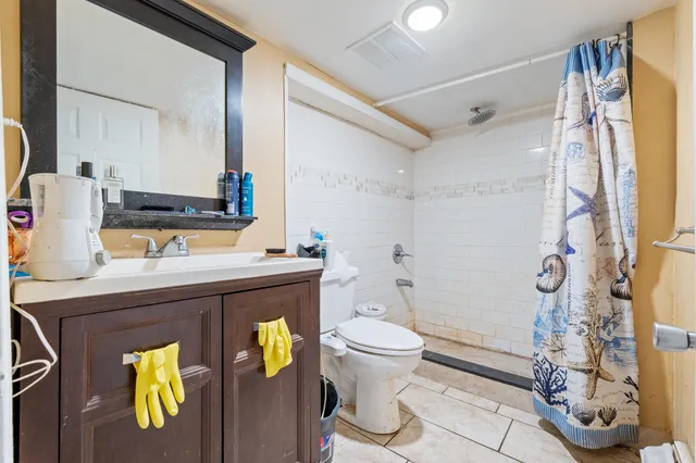 a bedroom with a bed couch and a window